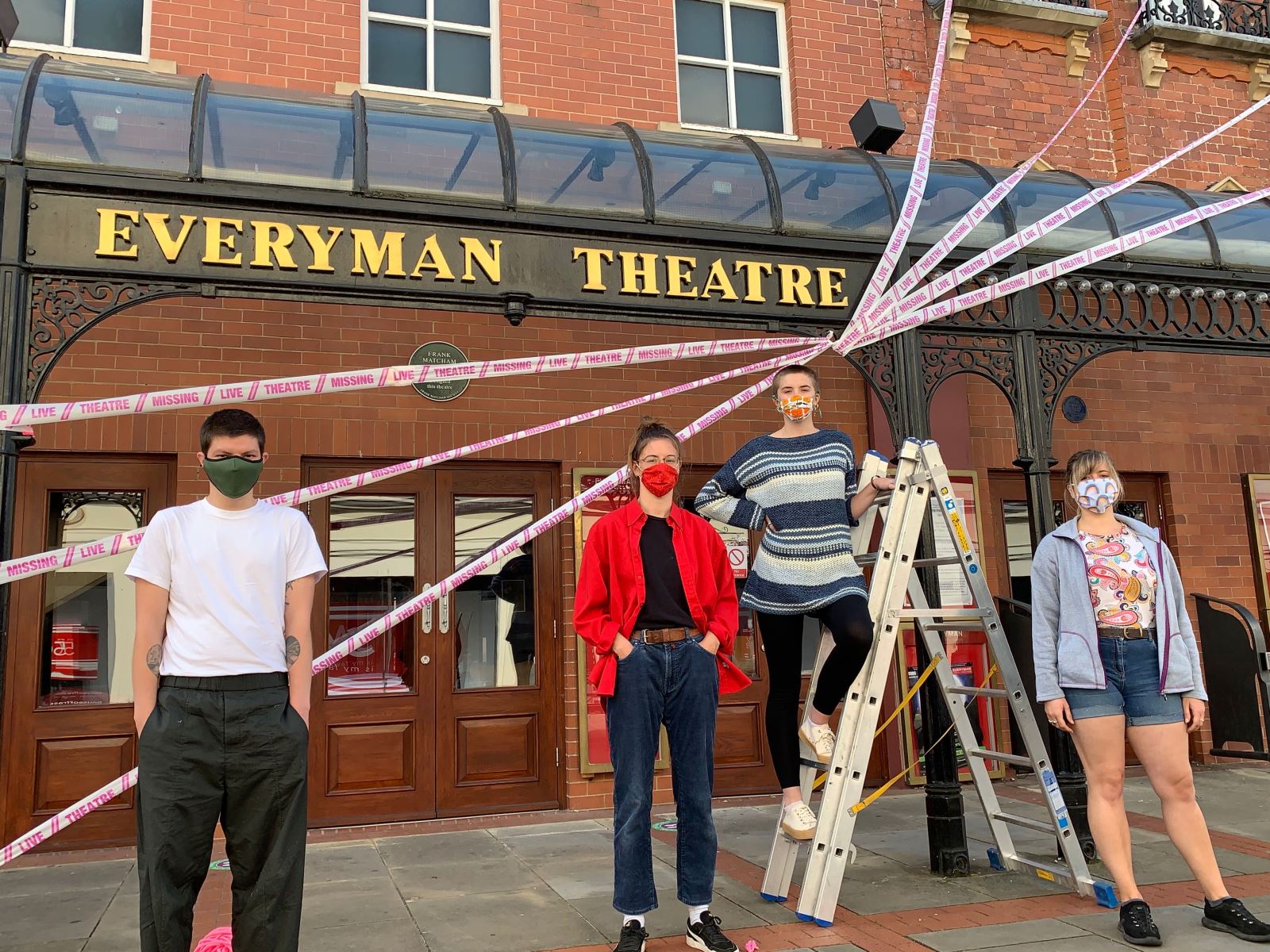  From l to r: Jacob Lucy, Lauren Dix, Dora Furnival and Lucy Fowler from Scene Change wrap the Everyman Theatre, Cheltenham in decorative #missinglivetheatre ribbon. 